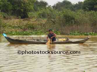 Man Fishing From Canoe