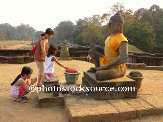 Girls Praying at Statue
