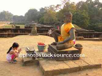 Girls Praying at Statue