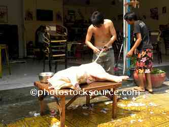 Man Butchering Pig