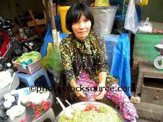 Woman Cutting Chilies